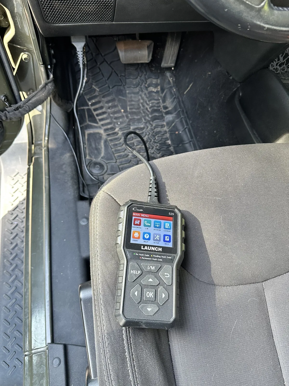 Scanner plugged into the OBD2 port under the dash
